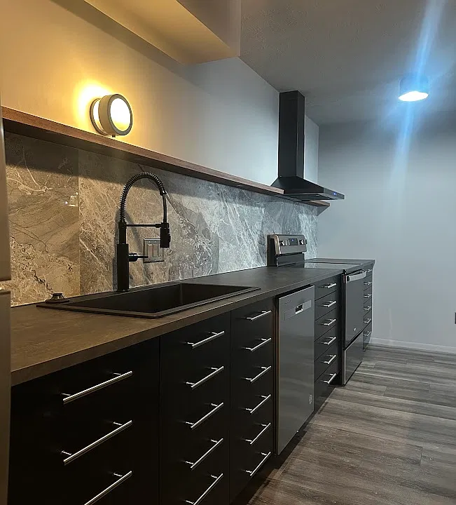 Large format backsplash tile + a wide, single basin kitchen sink with articulating faucet for easy cleanup.