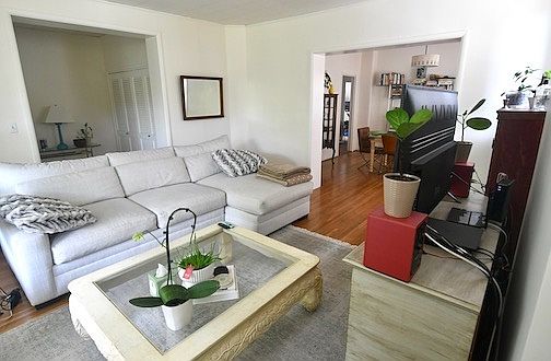 Living room, with open feel and large door openings to foyer, and Dining Room.