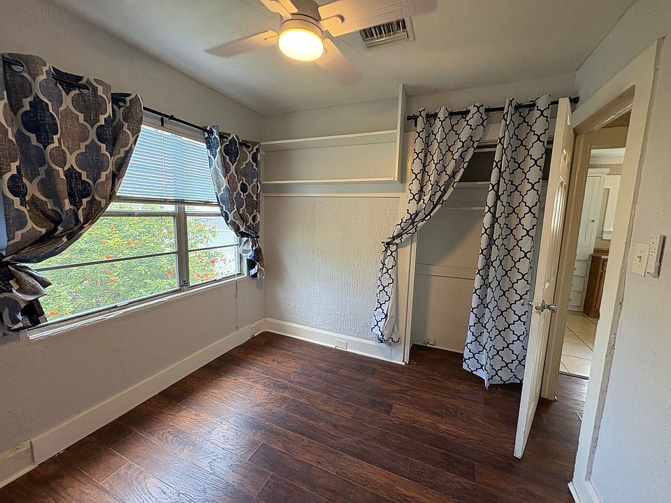 Bedroom 1 with window treatments and a new ceiling fan with remote