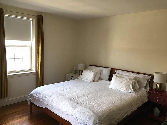 Large bedroom with windows on two walls.