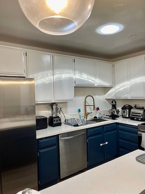 Stainless steel appliances and quartz stone counter and pendant lights. Solar tubes in kitchen provides natural light.