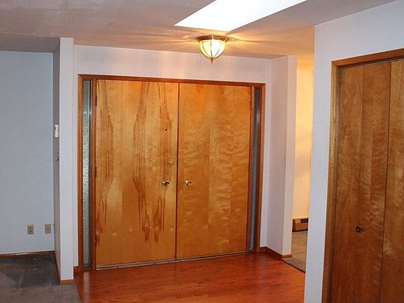 Front entry with double doors and skylight for natural light.