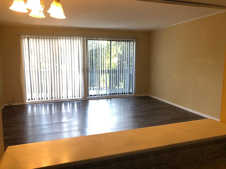 LR with plank flooring and large private balcony.