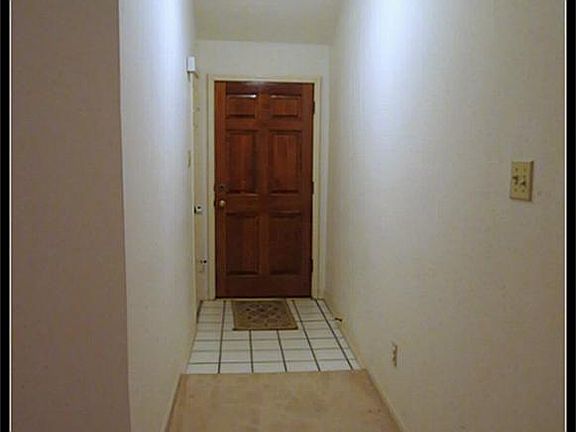 Entry with solid wood front door.