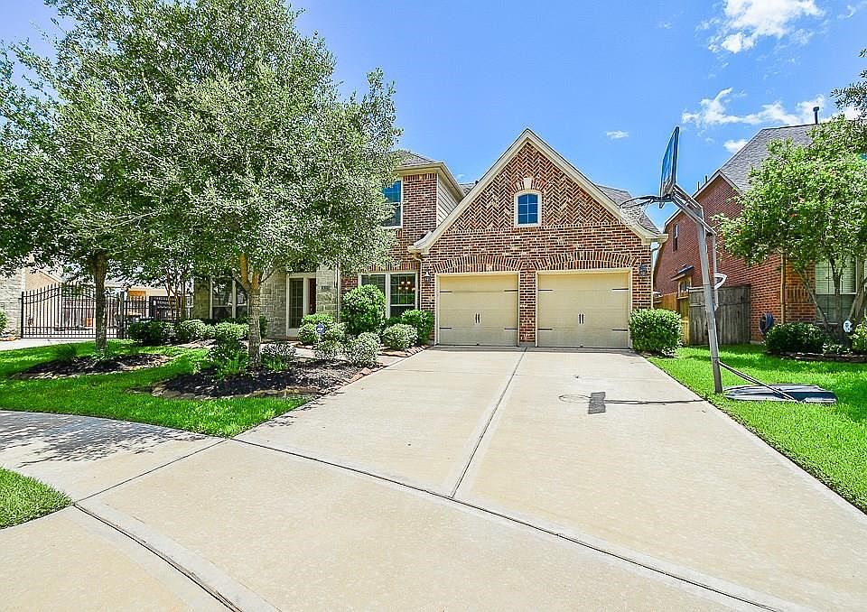 The double wide drive way leads you into a three car tandem garage.