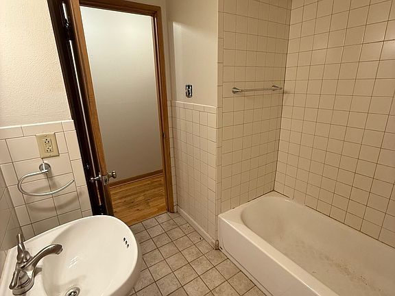 Main Bath features shower/bath combo, sink, toilet and storage closet.