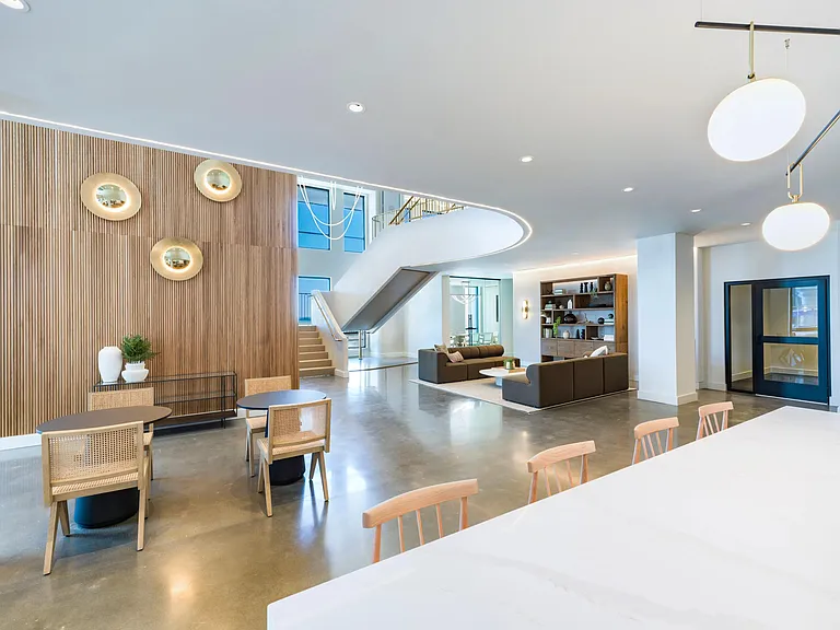 A welcoming lobby with layered seating, warm finishes, and space to gather, work, or unwind throughout the day.