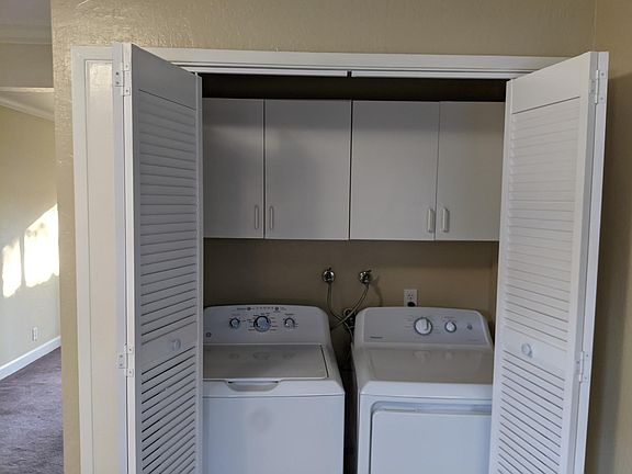 New washer & dryer with additional storage. The laundry area adjoins kitchen.
