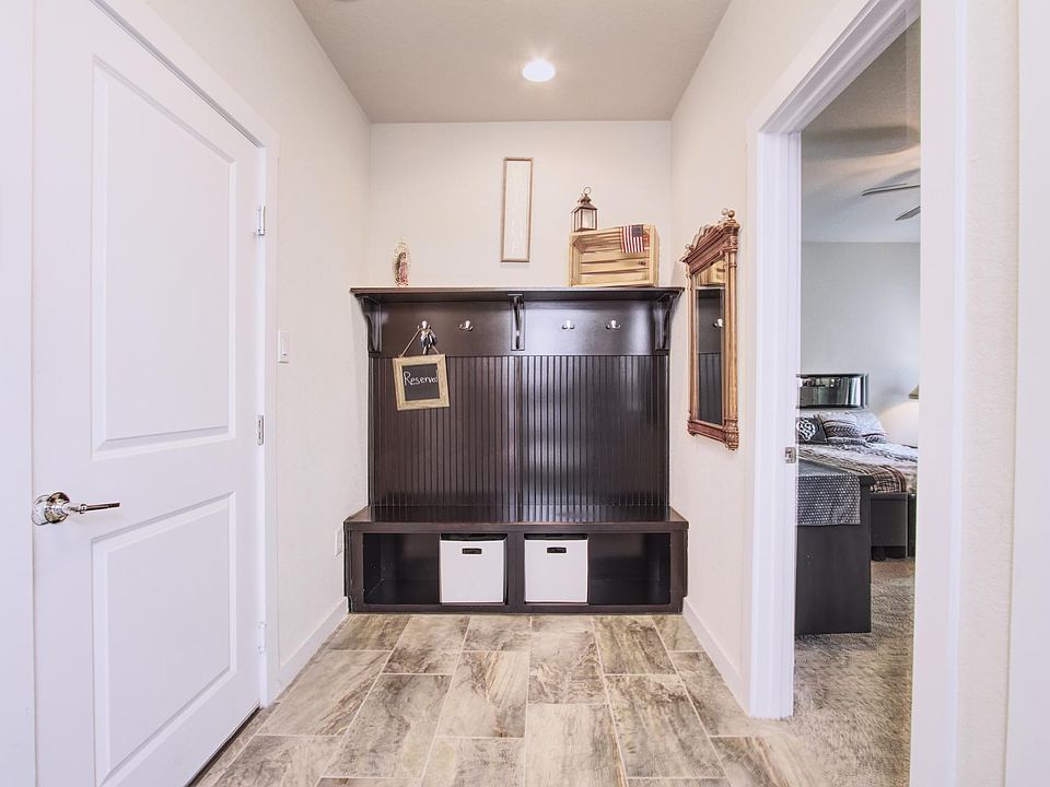 1st floor mud room with installed coat/hat hooks and room for storage. Garage access.