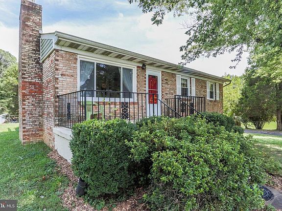 Charming brick Rambler with Red door.