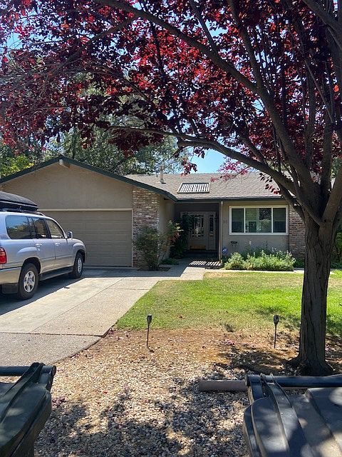 Front with ample parking in driveway and 2 car garage