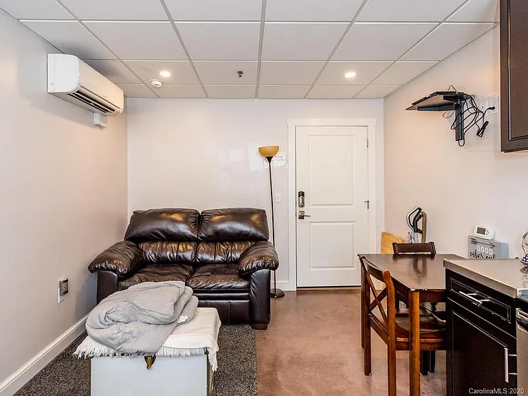 Living space - furnished with loveseat, table and two chairs.