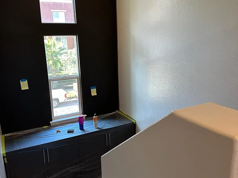 view cabinets and accent. wall from top of staircase at second floor.