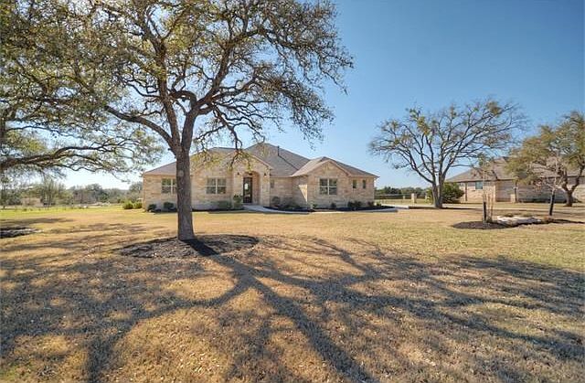 Native trees dot the landscape at this beautiful Shady Oaks custom home, where a Three-Car Side-Entr