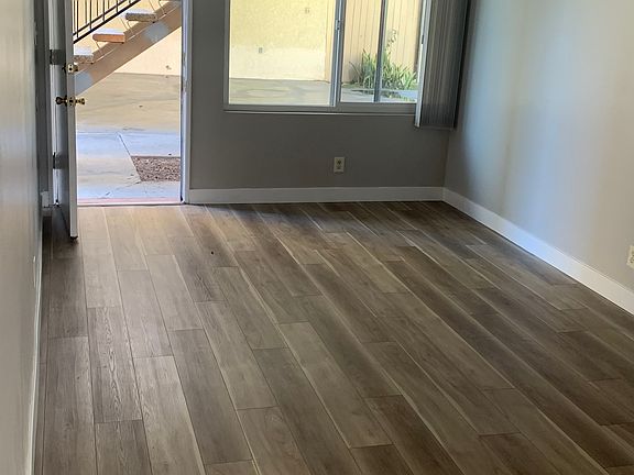 Living room and main entrance with new vinyl plank flooring and paint