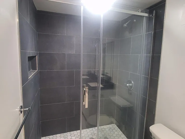 Nice ample shower, marble hexagonal floor.