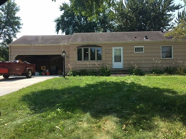 Front. New concrete driveway and attached garage.