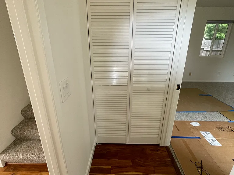 Entry showing stairs and laundry closet