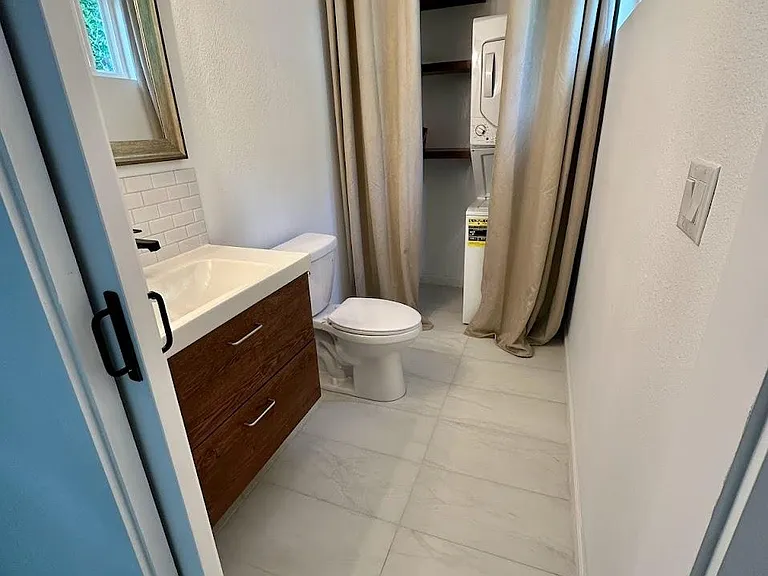guest bath downstairs with washer/dryer.