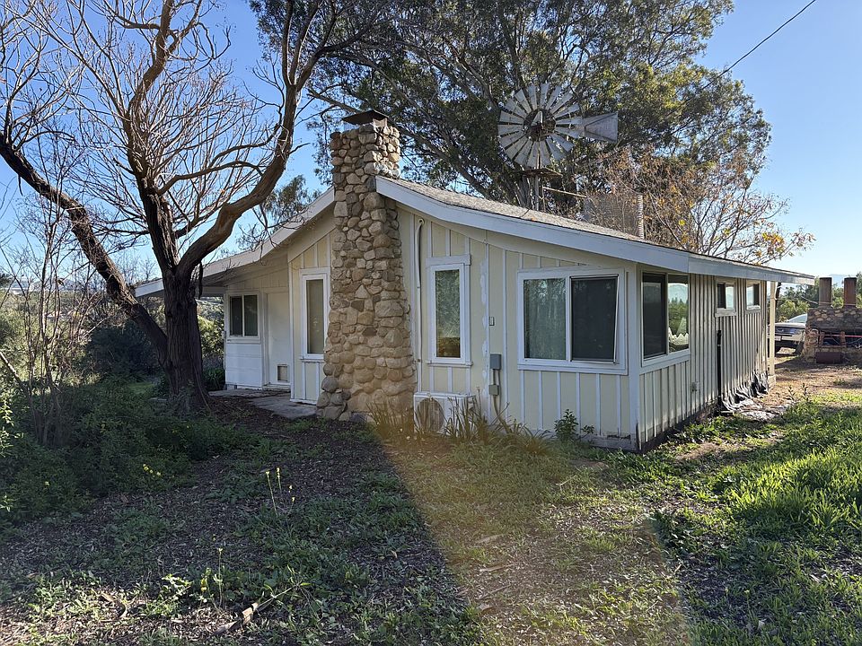 The Cottage with old windmill in the back