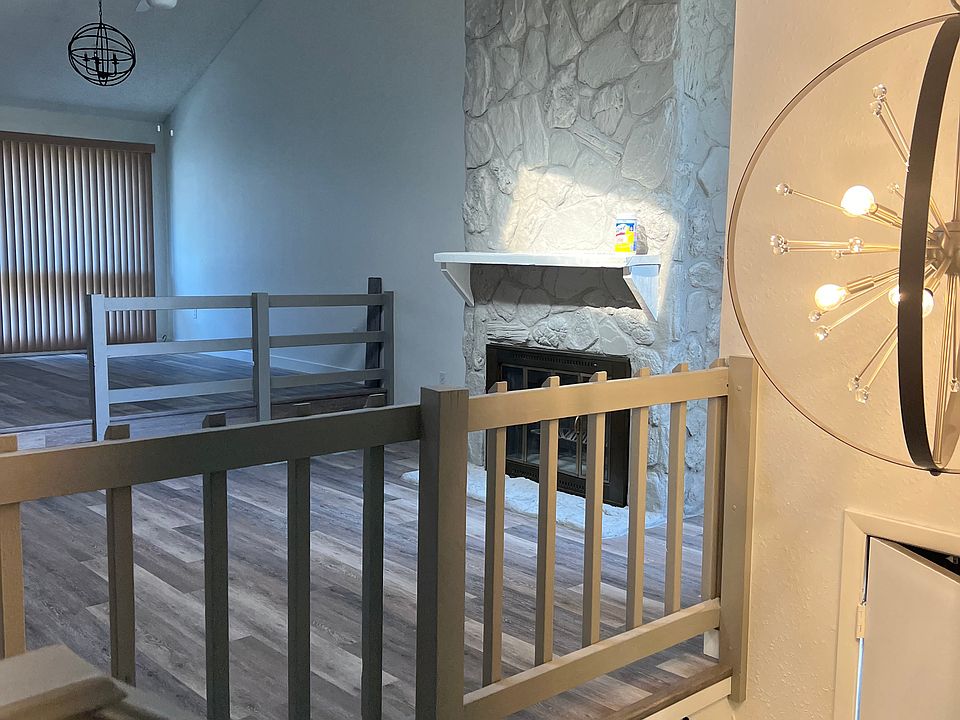 Entry, living room, fresh paint, new fan, step to dining area, wood burning fireplace, new flooring