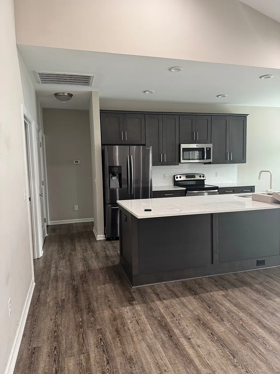 Standing at front door looking at kitchen and down hall to 2 bedrooms and bath - 103 Grand Ct N