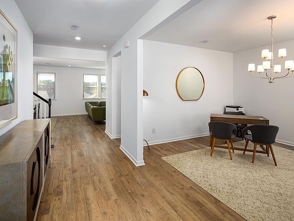 Home office off the entryway, flowing seamlessly into the living room.