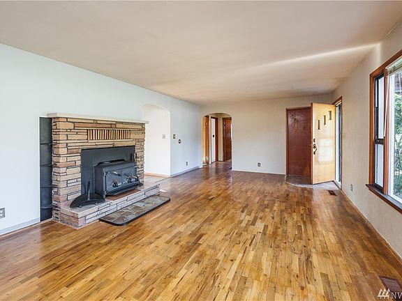 Living room has hardwood floors that continue through hallway and front bedroom