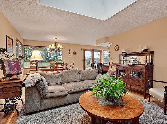 Another view of the living room looking from the fireplace back towards the kitchen/dining area. Sli