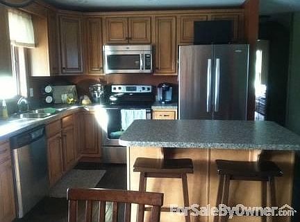 Glazed maple cabinets
						:
						Stainless appliances, hand scraped hardwood floors, bar stool seating at island