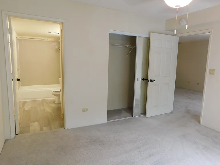 Primary bedroom; closet with mirrored sliding doors. Primary bathroom.
