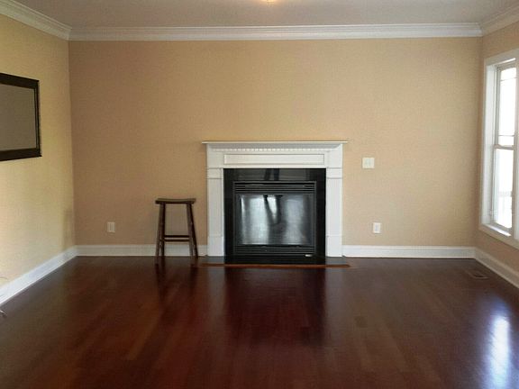 Living room with gas fireplace opens to screened in porch