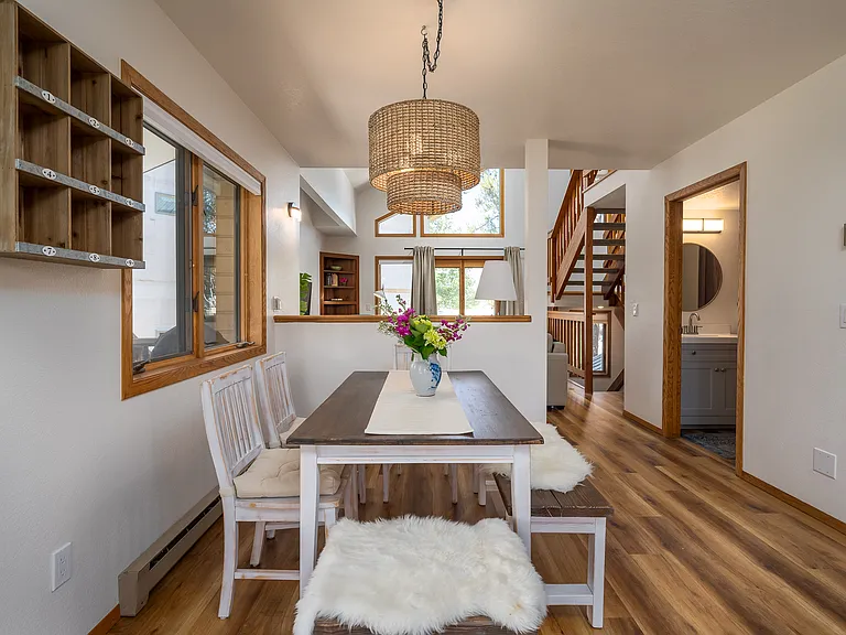 Dining area with view into the living room. The home is nice and sunny.