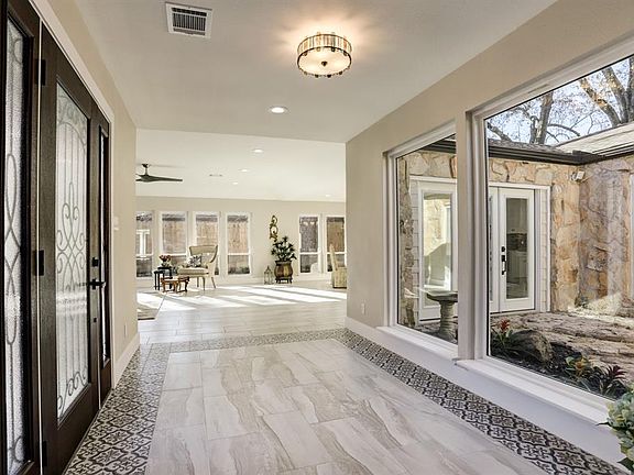 WOW, Enter to the Foyer and you begin to see what separates this home from any other! You Can't Miss the Immense Picture Windows Showing the Distingushing Feature of the Home, the ATRIUM! The beautiful tile framed by exquisite tile, framed by rich Ol