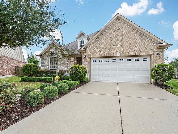 Beautifully maintained landscaping adds to the curb appeal of this gorgeous home