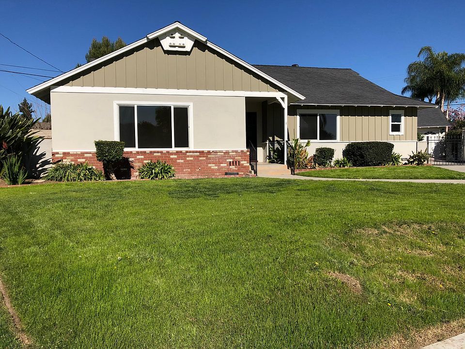 Front of home, wrought iron gate to garage is to left