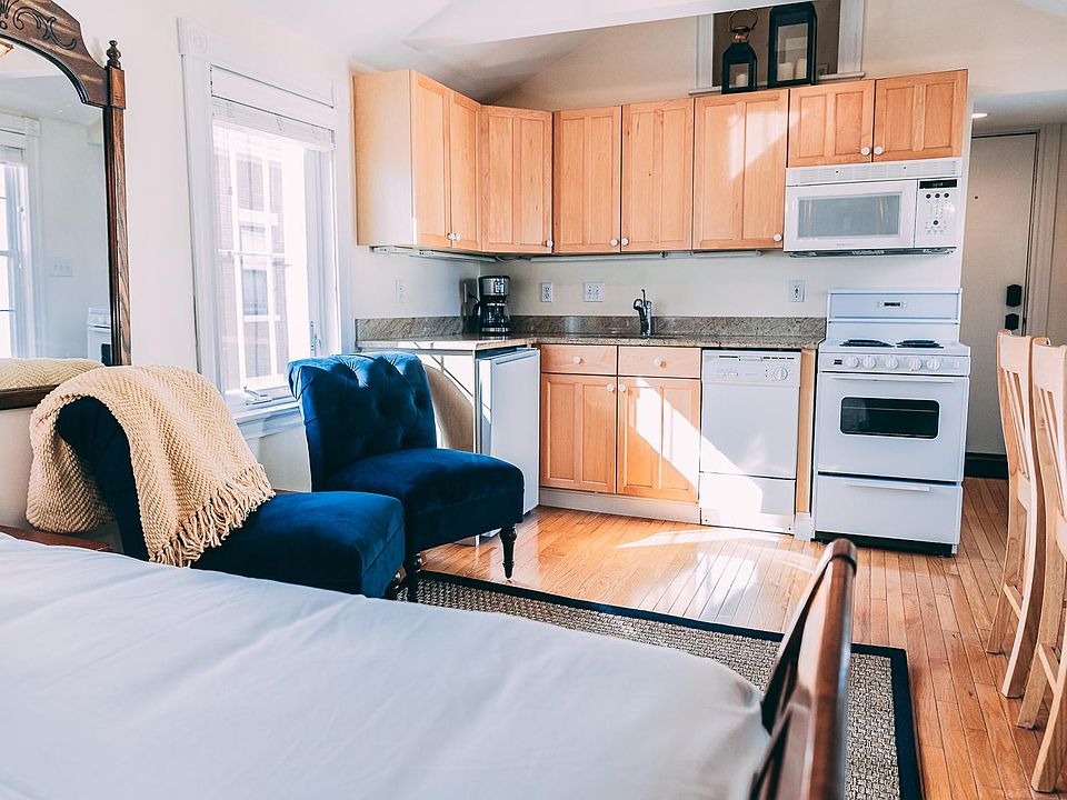 Full kitchen with a refrigerator, dishwasher, stove and microwave