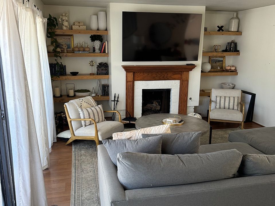 Large LR with fireplace, floor to ceiling windows leading to balcony and dining room. Open floorplan