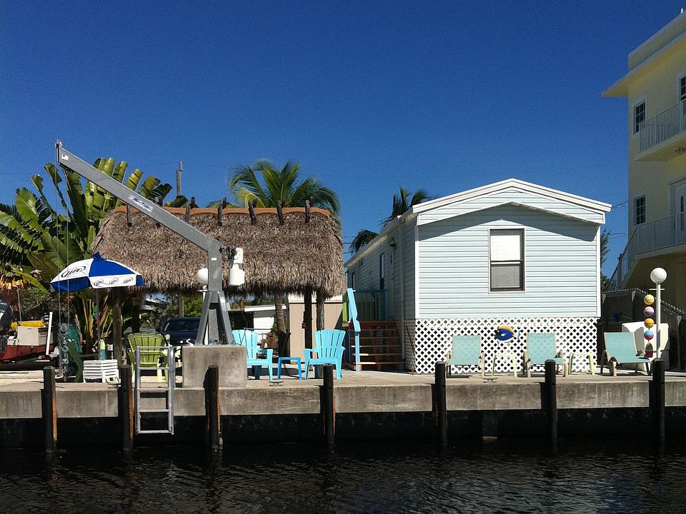 View from canal - home, new dock, and Tiki Hut