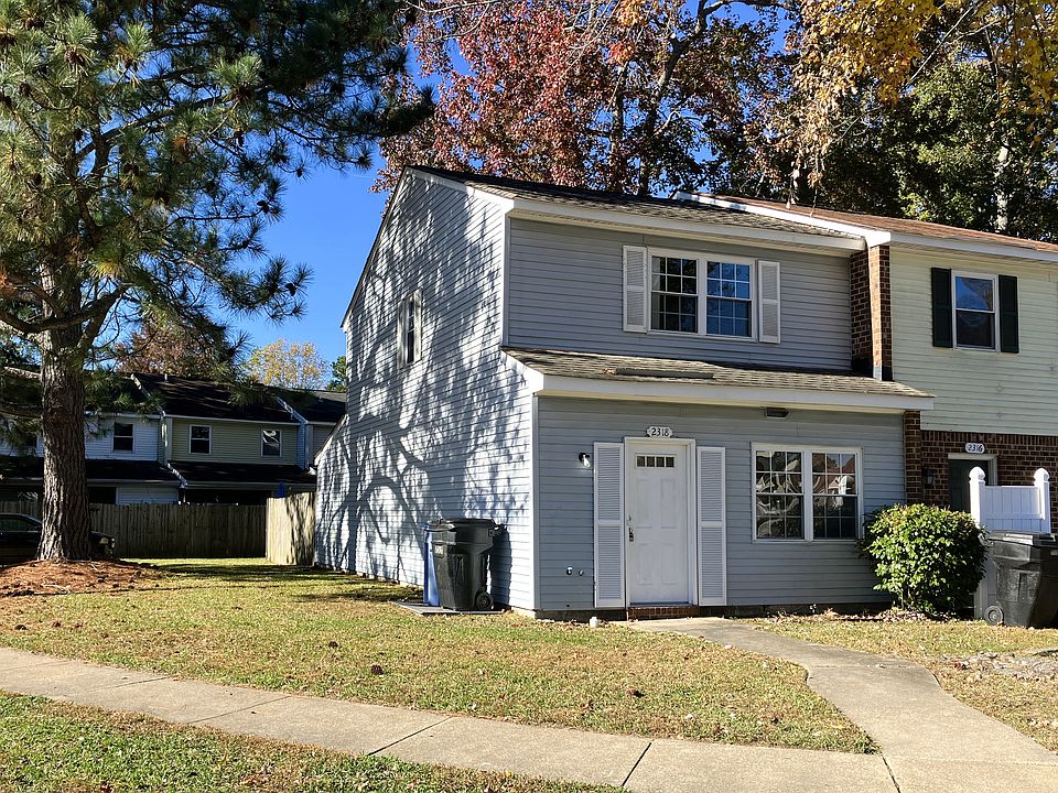 Exterior front w/ driveway parking on side of unit