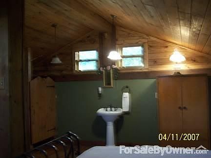Upstairs B/R Miss Carris's Cottage : Upstairs- wood cathedral ceilings, cute pedestal sink; toilet s