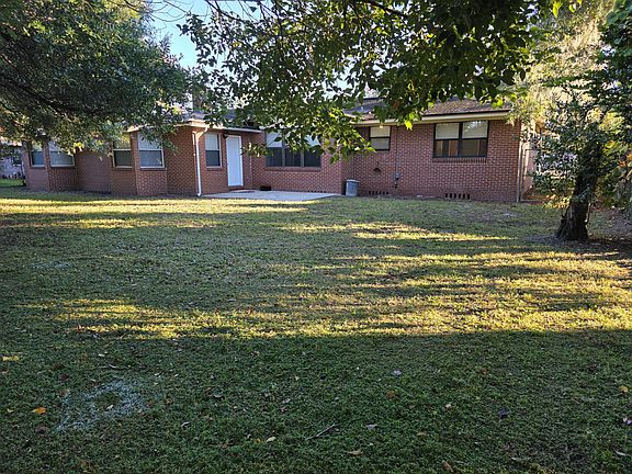 Back Yard - Viewing the patio and door that opens the a large room and master bedroom with bathroom that can be used as a mother-in-law suite