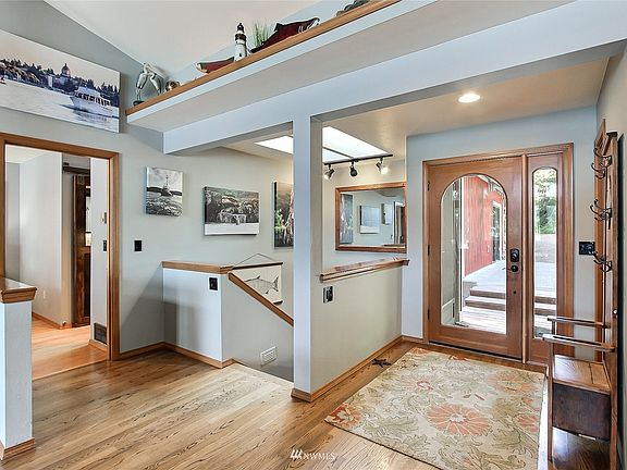View of main entry. Stairs down straight ahead, master bedroom on your left. You will love the expansive cathedral ceilings on this floor. >