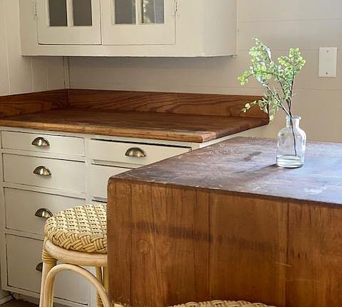 Kitchen has built in glass cabinets
