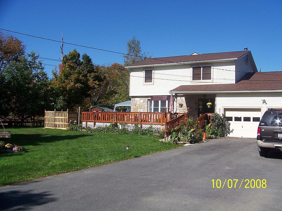 Front view-Southside,front deck wraps around to rear w/ 30 ft fenced garden 