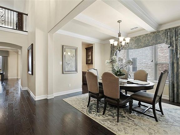 A GORGEOUS BEAMED CEILING, AND LARGE WINDOW WITH CUSTOM WINDOW TREATMENTS,  HIGHLIGHTS THE FORMAL DINING ROOM.  THERE'S EVEN A SPACIOUS BUTLERS PANTRY PERFECT FOR ENTERTAINING!