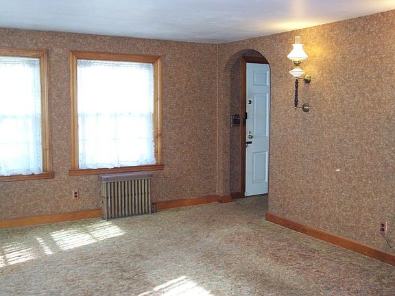 Living room with hardwoods under carpet