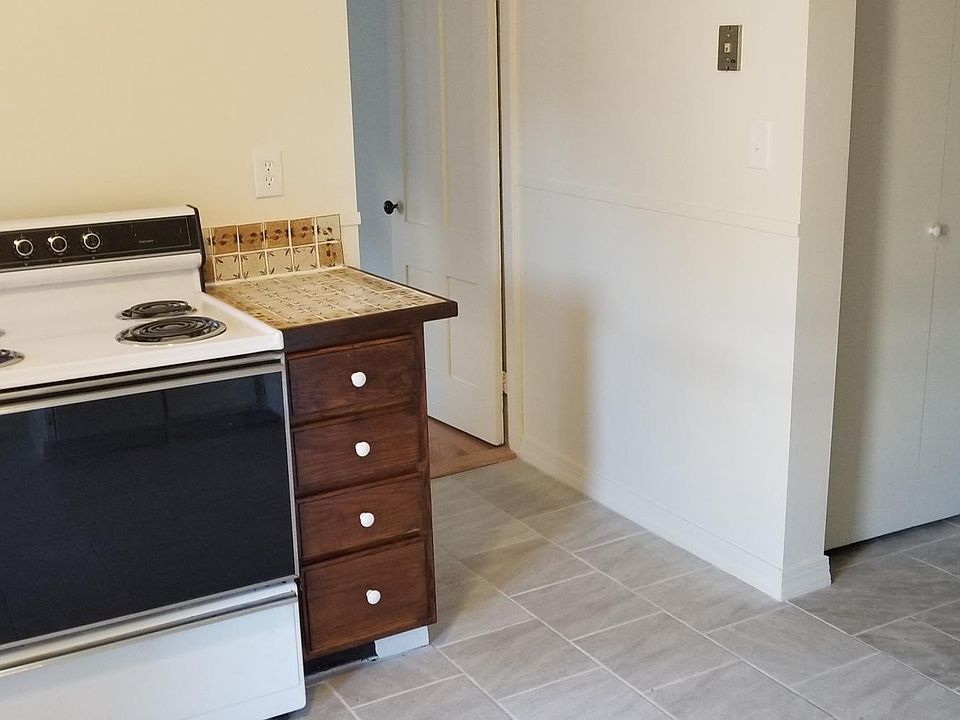 KITCHEN WITH OPENING TO BEDROOM AND WASHER/DRYER CLOSET TO THE RIGHT