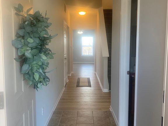 Grand entry way with convenience of half bath for guests
