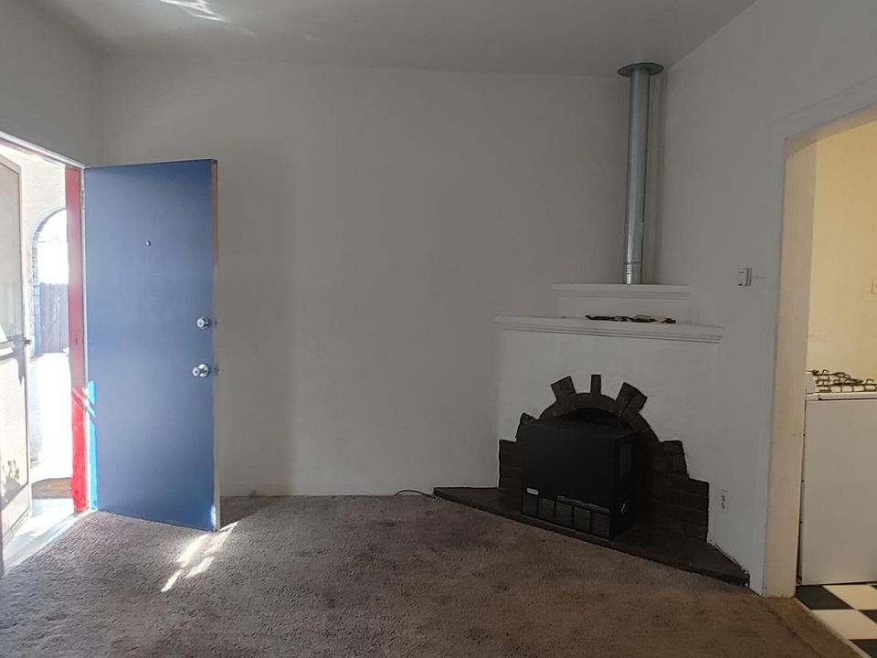 View of living room showing converted fireplace.